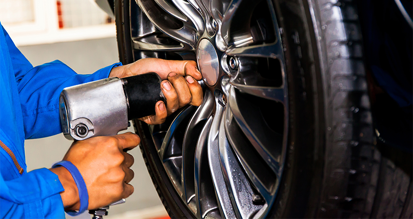 Technician fitting a new tyre